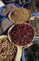 Baskets of dried flower heads and leaves for sale at market.   Marrakesh