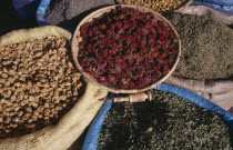 Baskets of dried flower heads and leaves for sale at market.   Marrakesh