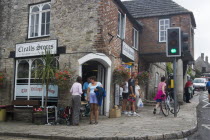 People gathered outside a village shopGreat Britain United Kingdom Store UK