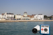 View from the pier across the sea towards The Dome Cinema and Marine Parade cafes. Viewing telescope in the foreground.Great Britain United Kingdom  Grade II listed building UK