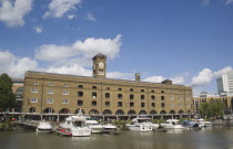 St Catherine s Dock with yachts moored next to the former warehouses which are now luxury apartments.United Kingdom Great Britain UK