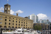 St Catherine s Dock with yachts moored next to the former warehouses which are now luxury apartments.United Kingdom  Flats motorboats Great Britain UK