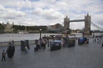 The Queens walk open air exhibition outside the GLA city hall with Tower Bridge behind.United Kingdom  Greater London Authority Thames Southbank Great Britain UK