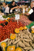 Fruit and vegetable stall in the Rialto market with shoppers and vendors