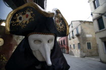 Masked Carnival figure outside a shop in the San Polo district Store