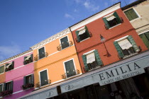 Brightly coloured houses above lace shops on the lagoon island of Burano  historically the centre of the lace making industry in the regionCenter Colored