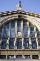 The front of the Gare du Nord railway station with statues and clock