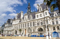 The Paris Plage urban beach. Young people playing beach rugby football in front of the Hotel de Ville Town Hall