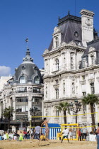 The Paris Plage urban beach. Young people playing beach volleyball in front of the Hotel de Ville Town Hall