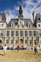 The Paris Plage urban beach. Young people playing beach volleyball in front of the Hotel de Ville Town Hall