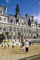 The Paris Plage urban beach. Young people playing beach football in front of the Hotel de Ville Town Hall