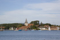 View across water toward Old Bosham with the church spire visibleGreat Britain UK United Kingdom