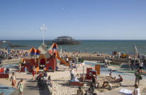 Childrens play area with the ruins of the West Pier behind.Great Britain United Kingdom