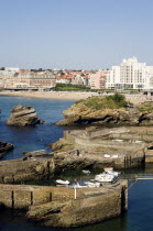 The Basque seaside resort on the Atlantic coast. Boats in the safe harbour of the Port des Pecheurs with the Grande Plage and town beyond