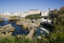 The Basque seaside resort on the Atlantic coast. Boats in the safe harbour of the Port des Pecheurs with the Grande Plage and town beyond