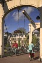 Cyclists crossing Magere Brug  Skinny Bridge.HolidaysTourismNetherlands