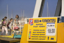 Boarding a passenger ferry bound for Formentera  Eivissa  with next departure sign.HolidaysTourismTravel