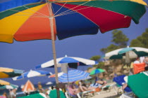 Parasols and sunbathers on the beach at Portinatx.  LeisureTourismHolidaysSunshineColour