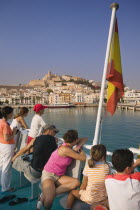 Passengers on board a ferry leaving Eivissa for Formentera  Spanish flag.HolidaysTourismTravel