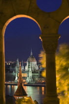 Night time view of Parliament over the Danube from Fishermens Bastion  viewed through arches.HolidaysTravelTourismNeo Gothic ArchitectureEastern Europe