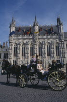 Tourist horse and carriage outside the Stadhuis in Burg Square Flemish Region