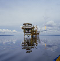 Hudbay oil platform in calm sea with burn off flame Gasoline