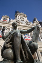 One of several female bronze statues in front of the Hotel de Ville town hall adorned with French tricolour flagsFrench Western Europe European