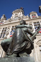 One of several female bronze statues in front of the Hotel de Ville town hall adorned with French tricolour flagsFrench Western Europe European