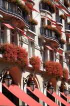 The facade of the five star Hotel Plaza Athenee on the Avenue Montagne in the heart of the haute couture fashion district with red geraniums in window boxes and red awningsFrench Western Europe Europ...