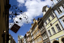 The Little Quarter Renaissance and Baroque buildings in Bridge Street with an ornate Pizza sign hanging over the streetPraha Ceska Eastern Europe European