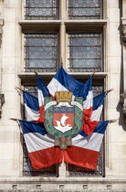 Formal display of French tricolour flags in a window on the facade of the Hotel de Ville Town HallEuropean Western Europe