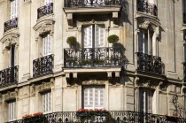 Apartment building with wrought iron balconies and shuttered windowsEuropean French Western Europe