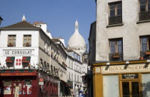 Boulangerie and shops by Le Consulat restaurant in Montmartre with the Ovoid dome of the church of Sacre Couer beyondEuropean French Religion Western Europe