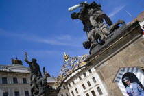 Sentry at guard box at the entrance to Prague castle beneath a statue of fighting giants by Ignaz Platzer in HradcanyPraha Ceska Eastern Europe European