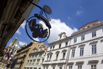 Renaissance and Baroque houses in Bridge Street in the Little Quarter with a restaurant sign hanging above the pavementPraha Ceska Eastern Europe European