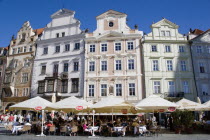 People at restaurant tables under umbrellas in front of the four houses named from left The Storch House  At The Stone Ram  At The Stone Table and U Lazara  At Lazaruss  on the south side of the Old T...