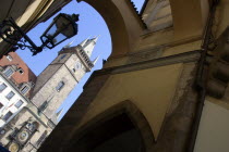 The Old Town Hall Clock Tower seen through an arch across the narrow Melantrichova PassagePraha Ceska Eastern Europe European