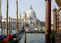 The Baroque church of Santa Maria della Salute in the Dorsoduro district with Gondolas on the Grand Canal in front of it