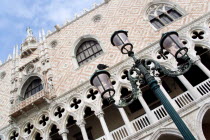 An ornate lamppost in front of the 15th Century quayside balcony of the Doges Palace