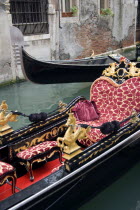 The Ferro  or bow  of a gondola passing another in a narrow canal