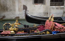 The Ferro  or bow  of a gondola passing another in a narrow canal