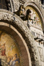 Two of the four bronze Horses of St Mark on the facade of the basilica above the Central Doorway and its 17th Century mosaics