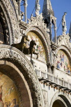 Two of the four bronze Horses of St Mark on the facade of the basilica above the Central Doorway and its 17th Century mosaics