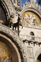 Two of the four bronze Horses of St Mark on the facade of the basilica above the Central Doorway and its 17th Century mosaics