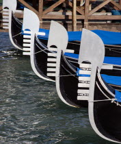 Silver bows  or Ferro  of gondolas moored at tghe Molo San Marco