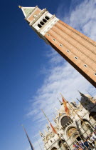 The Campanile tower and the Basilica of St Marks with tourists in the Piazza San Marco