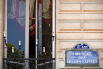 Street sign for the Avenue des Champs Elysees on a wall in the Huitieme Arrondissment next to a balcony with open window and candelabraEuropean French Western Europe