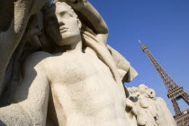 Stone sculpture of a man in the Trocadero Gardens with the Eiffel Tower in the distanceEuropean French Western Europe