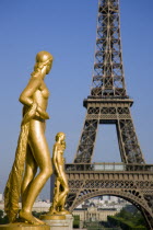 Gilded bronze statues in the Place de Chaillot at Trocadero with the Eiffel Tower in the distance European French Western Europe