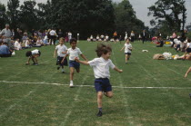 Five year olds taking part in running race during school sports day.European Great Britain Kids Learning Lessons Northern Europe Teaching UK United Kingdom